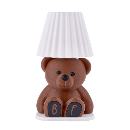 Teddy bear-shaped lamp with a white lampshade on a white background