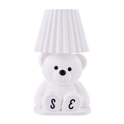 White teddy bear-shaped lamp with a striped lampshade on a white background