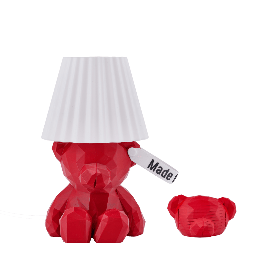 Red teddy boi bear-shaped lamp and a matching coasters with a white shade on a white background