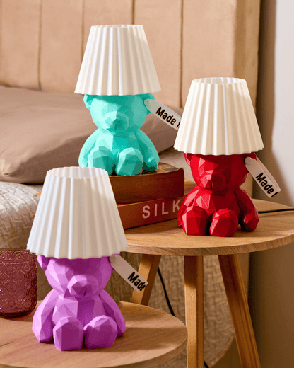 Modern prismatic 3D printed teddy bear lamp with a personalized name tag on the ear putted in the top of a wooden table