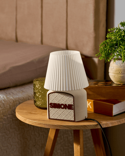 Art Deco glow Table lamp with textured design on a wooden side table in a cozy room setting.