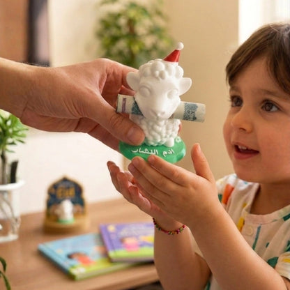 Child receiving a gift of small sheep money holder figurine with a Santa hat  from an adult indoors.