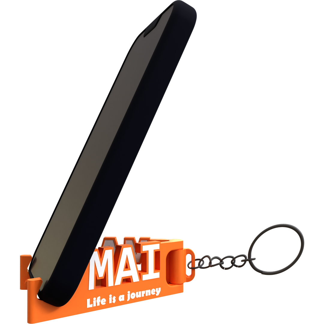 A black mobile phone stand with an orange keychain that has the text 'MAI Life is a journey' on it.